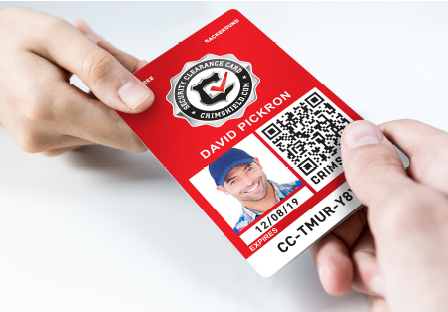 Two hands exchanging a physical CrimShield Security Clearance Card