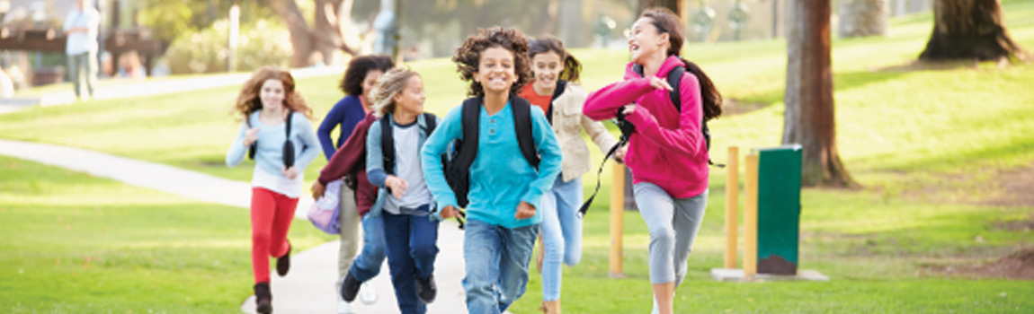 Children running with backpacks at school